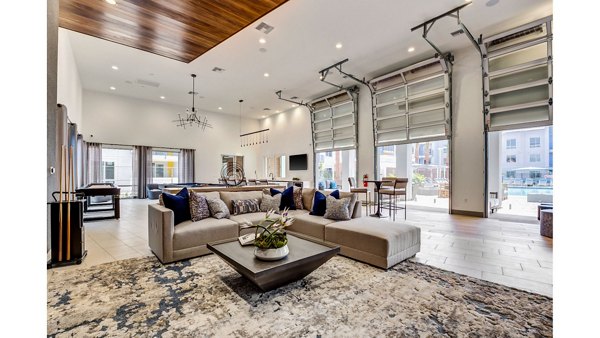 Clubhouse featuring modern design and comfortable seating at The Eisley Apartments, luxury community by Greystar