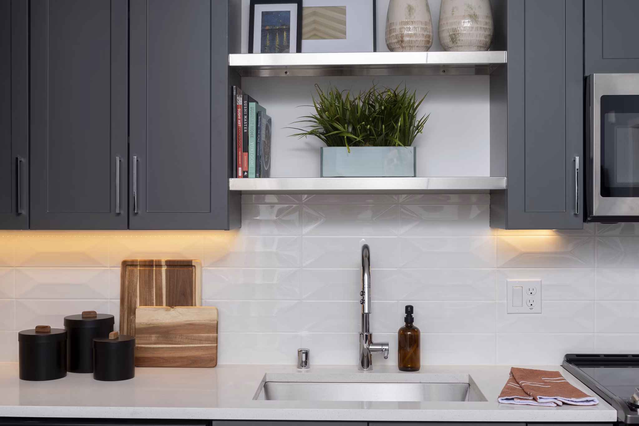 Modern kitchen with stainless steel appliances at The Eisley Apartments