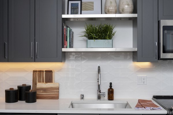 Modern kitchen with stainless steel appliances at The Eisley Apartments