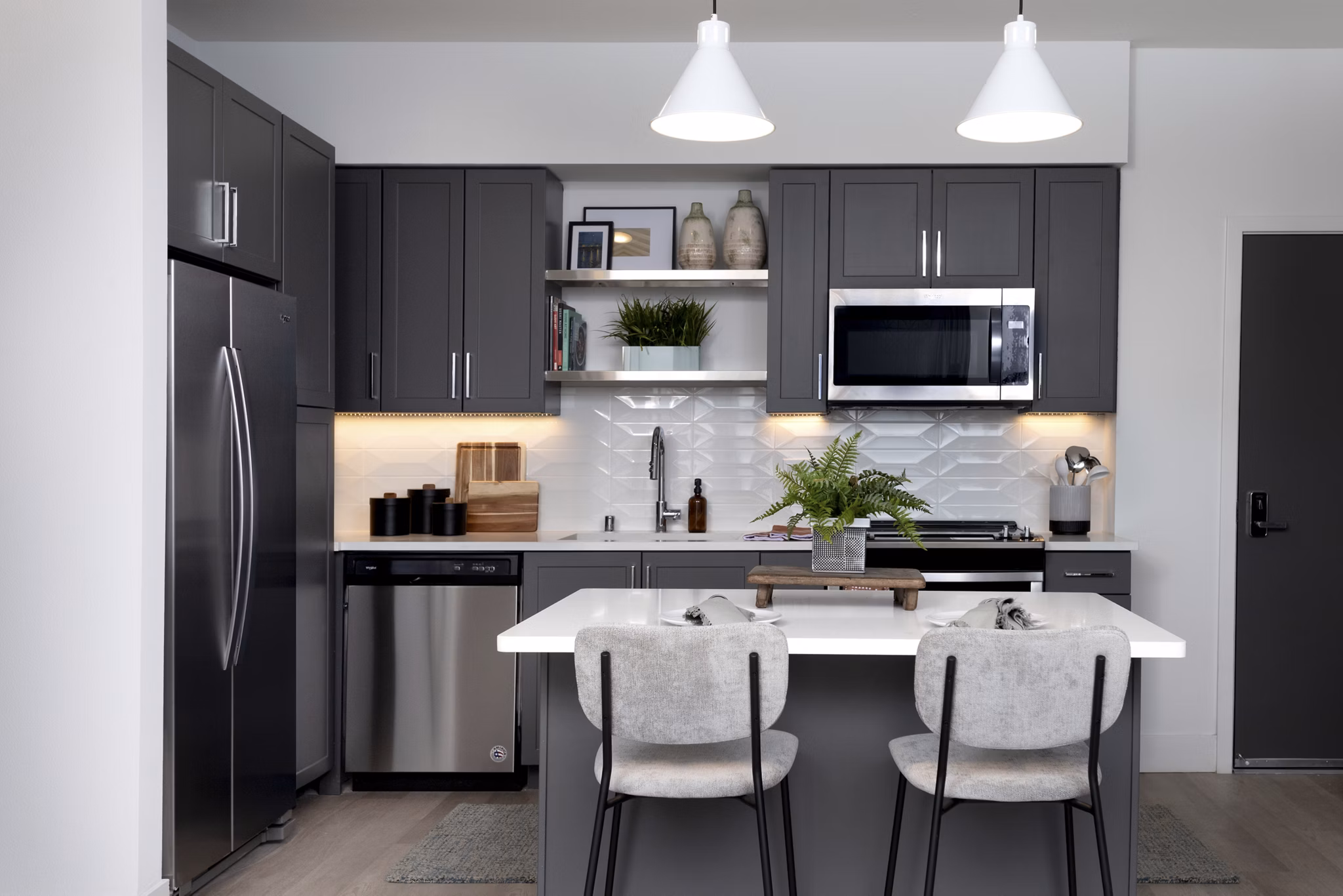 Sleek modern kitchen with stainless steel appliances at The Eisley Apartments