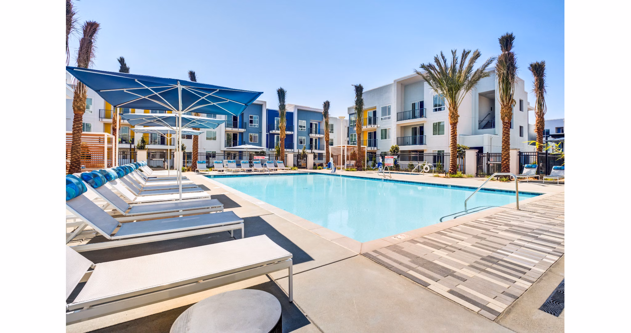 The Eisley Apartments: Luxury pool area with lounge seating and lighting in Sacramento