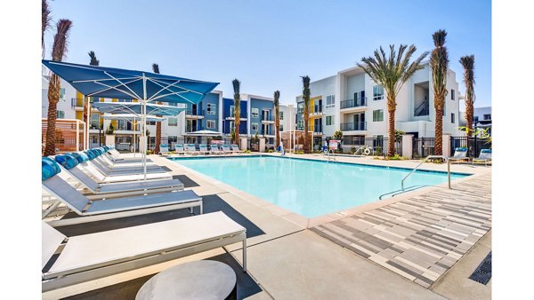 The Eisley Apartments: Luxury pool area with lounge seating and lighting in Sacramento
