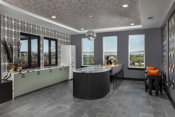 Clubhouse at Broadstone Berry Hill: Modern gathering area with sleek furnishings and community kitchen in a luxury apartment setting