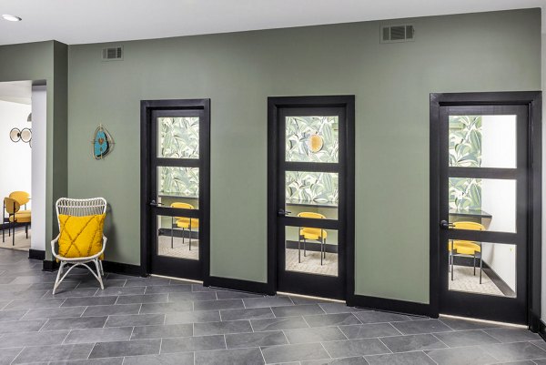 Clubhouse business center with modern workstations at Broadstone Berry Hill Apartments