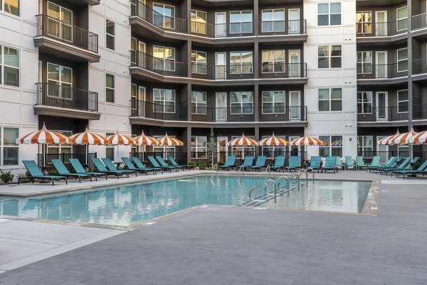 Broadstone Berry Hill: Luxurious pool area with lounge seating and greenery in Nashville apartments
