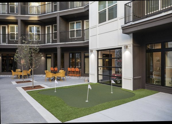 Putting green surrounded by lush landscaping at Broadstone Berry Hill luxury apartments