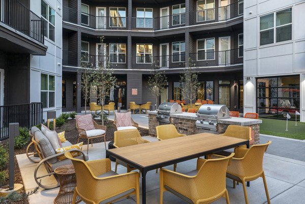 Outdoor grill area with modern seating at Broadstone Berry Hill
