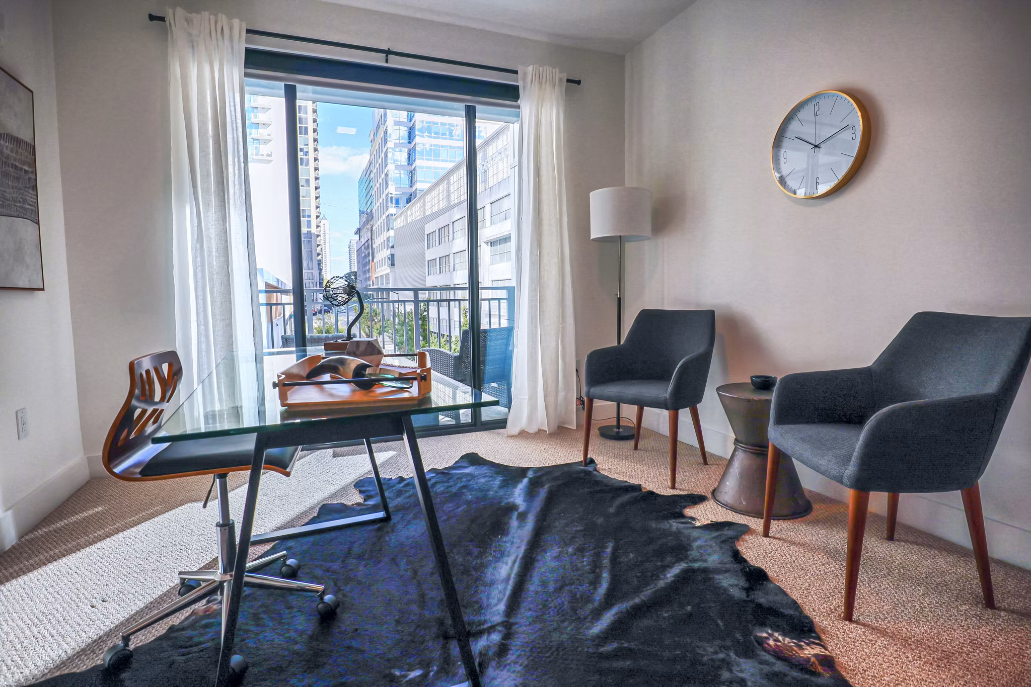 Home office with modern desk and natural lighting in Novel Midtown Apartments