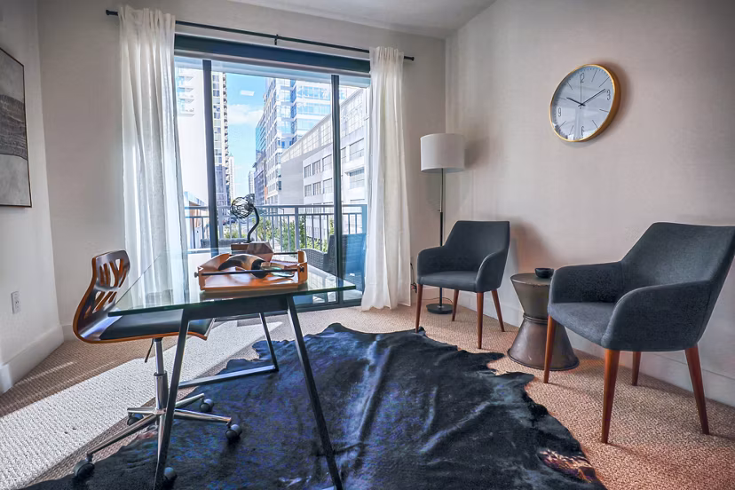 Home office with modern desk and natural lighting in Novel Midtown Apartments