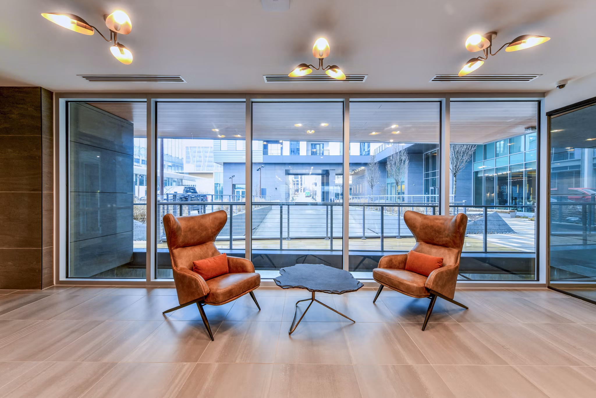Clubhouse featuring modern design and cozy seating areas at Novel Midtown Apartments