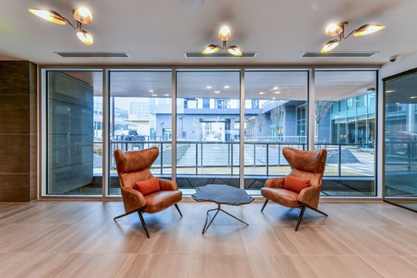 Clubhouse featuring modern design and cozy seating areas at Novel Midtown Apartments