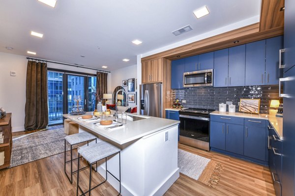 Modern kitchen featuring stainless steel appliances in Novel Midtown Apartments