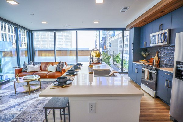 Modern kitchen featuring stainless steel appliances in Novel Midtown Apartments