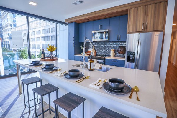 Modern kitchen with stainless steel appliances at Novel Midtown Apartments