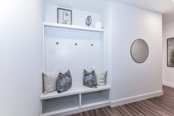 Stylish living room with modern decor and natural light at Novel Midtown Apartments