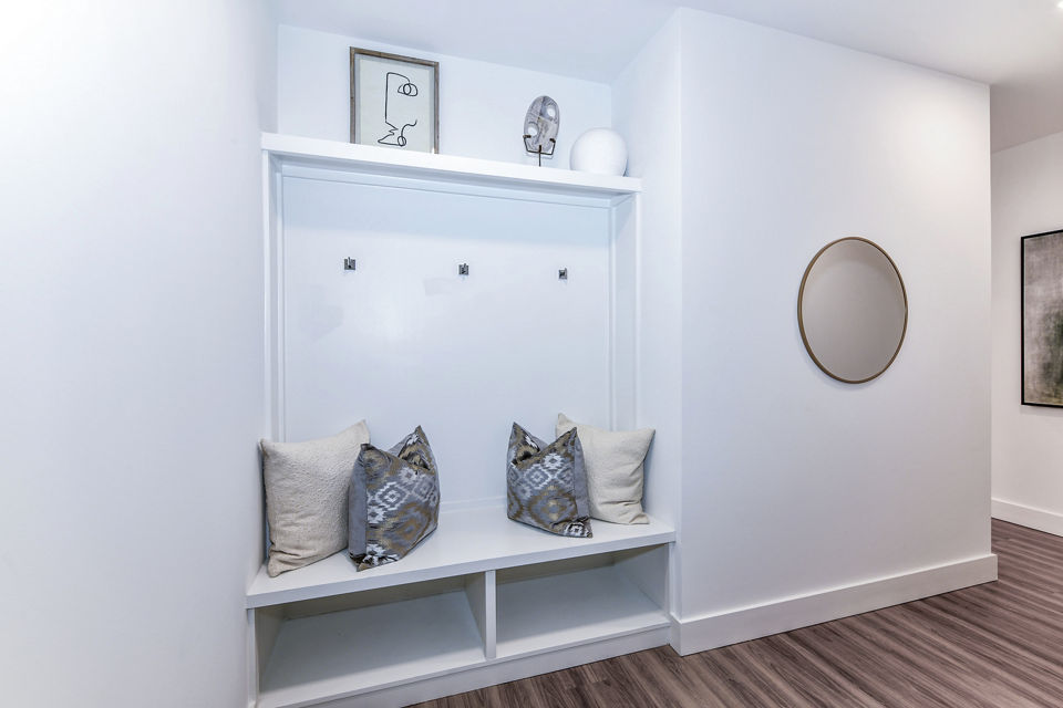 Stylish living room with modern decor and natural light at Novel Midtown Apartments