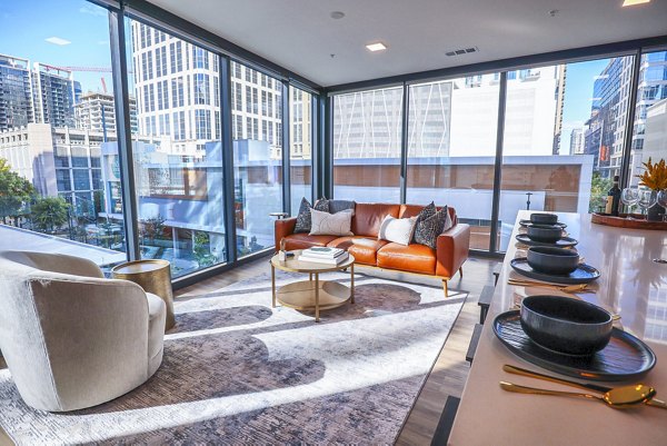 Spacious living room with modern decor at Novel Midtown Apartments, featuring comfortable seating and stylish lighting