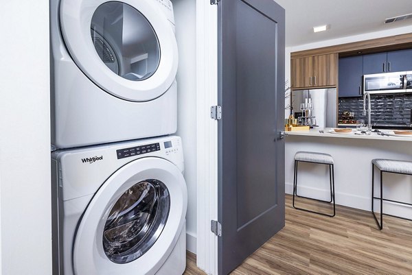 Laundry room featuring modern appliances in Novel Midtown Apartments luxury apartments