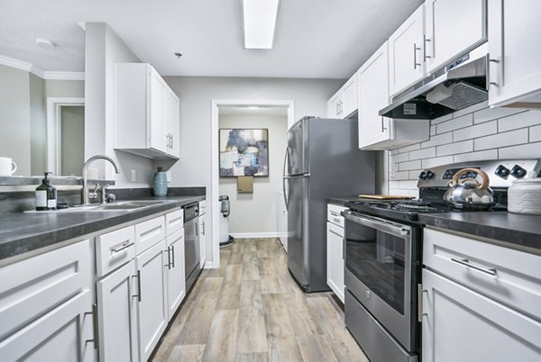 Modern kitchen with stainless steel appliances and granite countertops at Bridgewater Apartments
