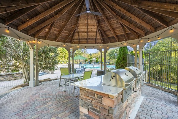 Outdoor BBQ grill area and patio at Bridgewater Apartments with modern seating and landscaping