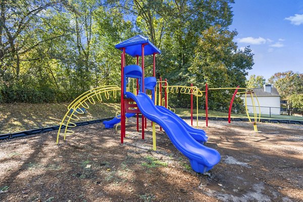 Colorful playground at Bridgewater Apartments featuring slides and climbing structures for residents' enjoyment and recreation