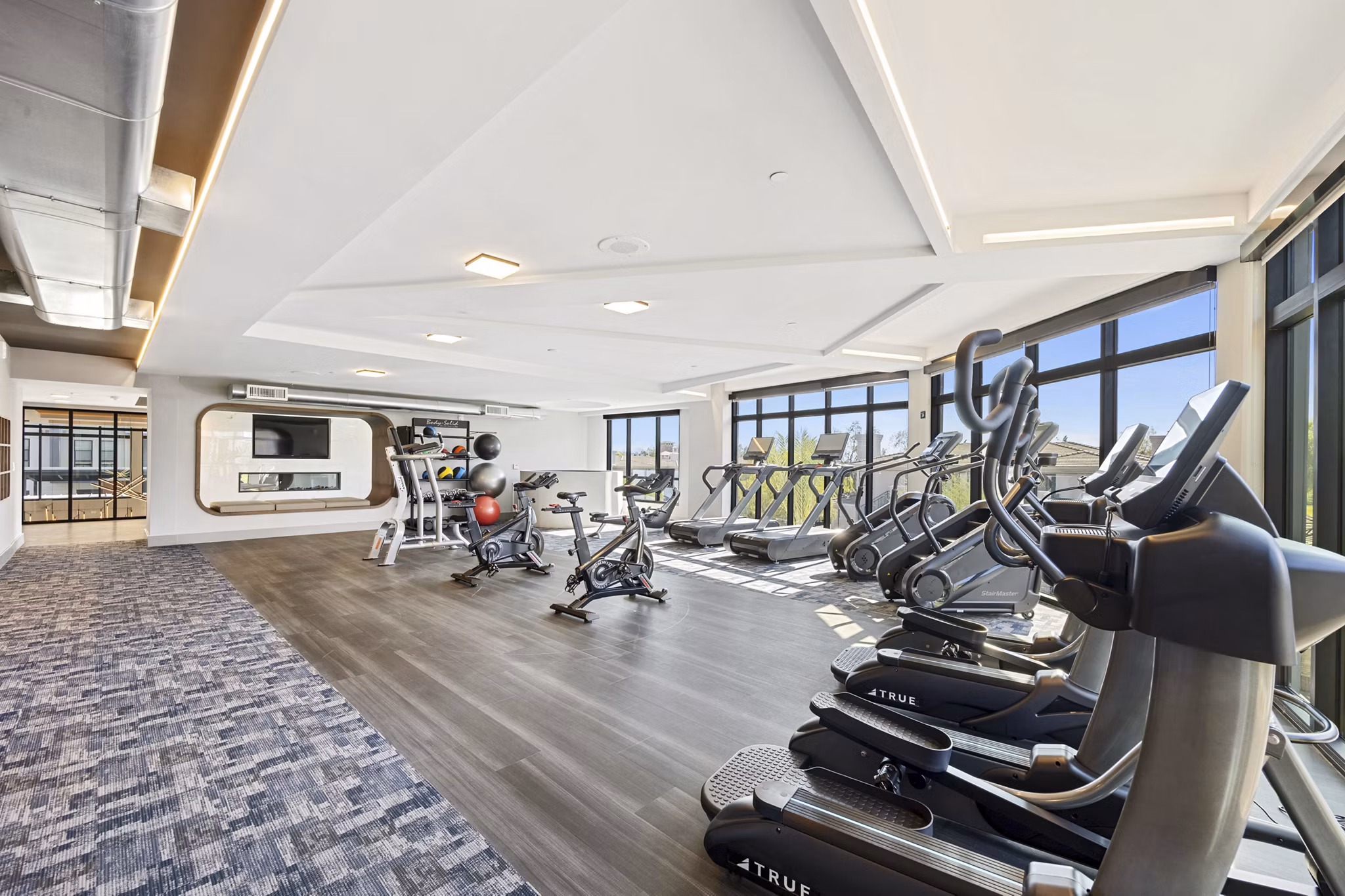 Fitness-focused yoga/spin studio at Soltra at Kierland Apartments with spacious area and modern equipment for residents' wellness