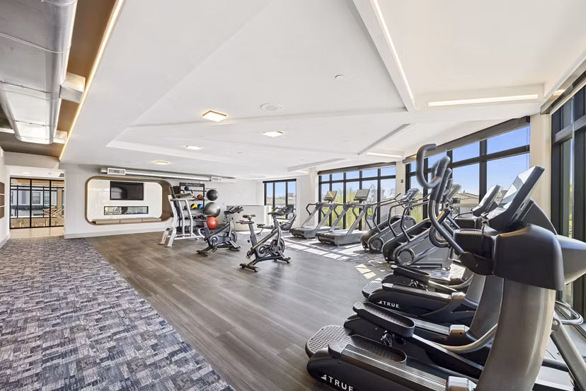 Fitness-focused yoga/spin studio at Soltra at Kierland Apartments with spacious area and modern equipment for residents' wellness