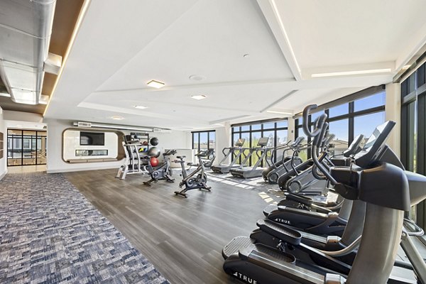 Fitness-focused yoga/spin studio at Soltra at Kierland Apartments with spacious area and modern equipment for residents' wellness