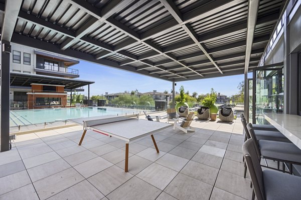 Outdoor patio with cozy seating and fire pit at Soltra at Kierland Apartments in a luxury setting