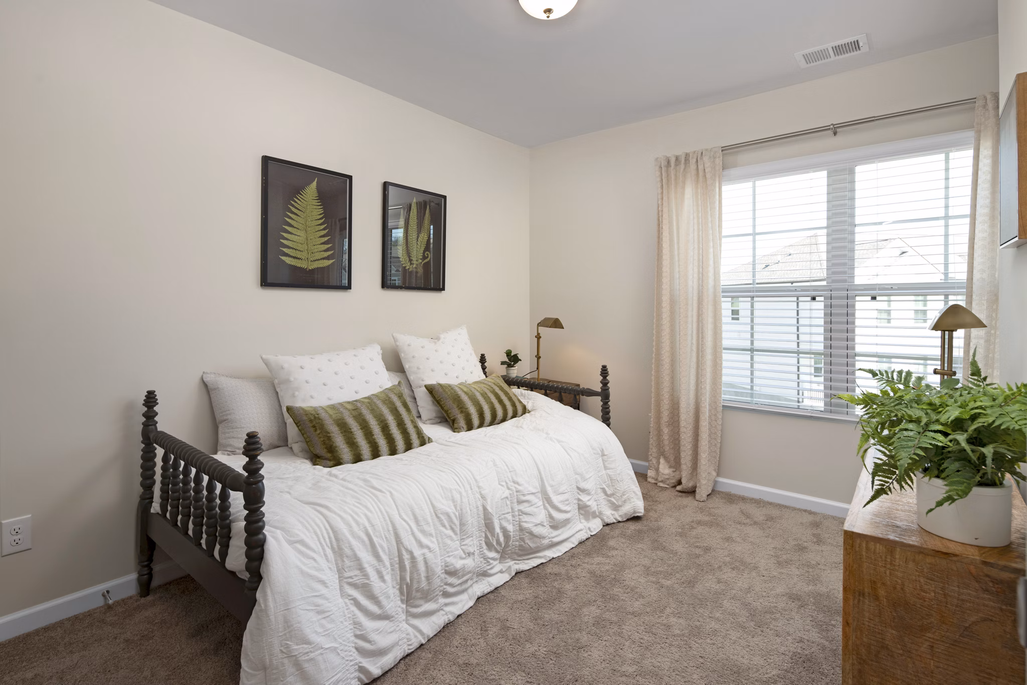 Cozy bedroom with natural light at Townes at Hamilton Apartments, featuring modern decor and ample storage spaces