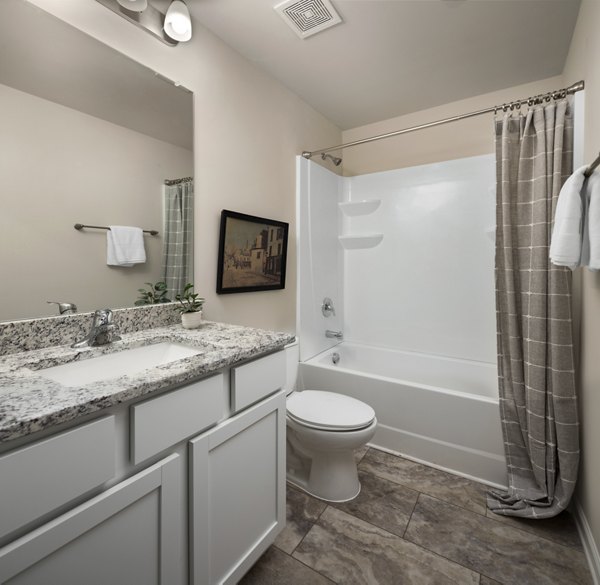 Modern bathroom with designer fixtures at Townes at Hamilton Apartments, offering luxury living with Greystar quality and comfort