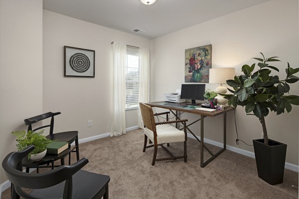 Modern home office with ergonomic desk and chair in Townes at Hamilton Apartments, offering a productive work-from-home environment