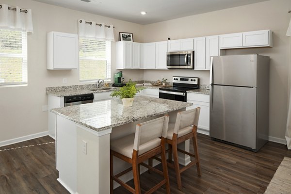Modern kitchen with stainless steel appliances at Townes at Hamilton Apartments