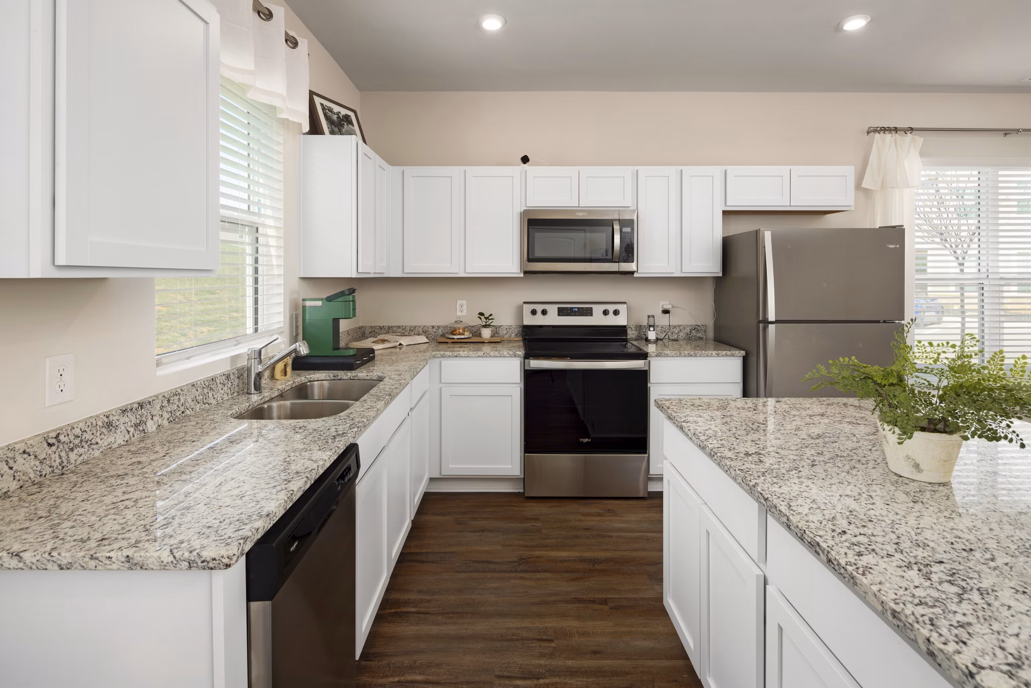 Modern kitchen with stainless steel appliances in Townes at Hamilton Apartments, showcasing sleek cabinetry and ample counter space