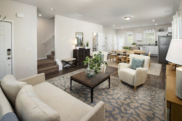 Bright living room with modern furnishings in Townes at Hamilton Apartments