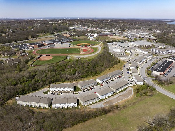 Townes at Hamilton Apartments: Scenic view of luxury apartments in lush landscape, ideal for upscale living