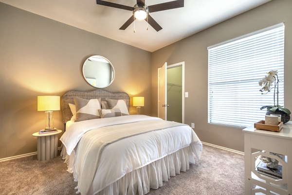 Elegant bedroom with stylish decor at Olympus Team Ranch Apartments