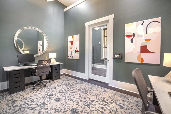 Business center for remote work with spacious seating and modern computers at Olympus Team Ranch Apartments