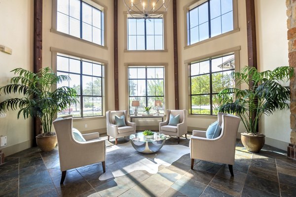 Clubhouse featuring a stylish lounge area at Olympus Team Ranch Apartments