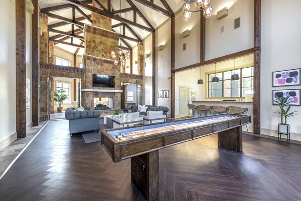 Clubhouse featuring modern design and comfortable seating at Olympus Team Ranch Apartments, luxury living by Greystar
