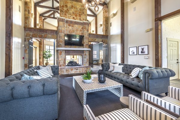 Clubhouse with modern design and seating area at Olympus Team Ranch Apartments, a luxury Greystar property