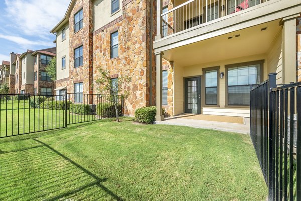 Patio at Olympus Team Ranch Apartments: Spacious outdoor area with modern furniture and greenery for relaxing and socializing
