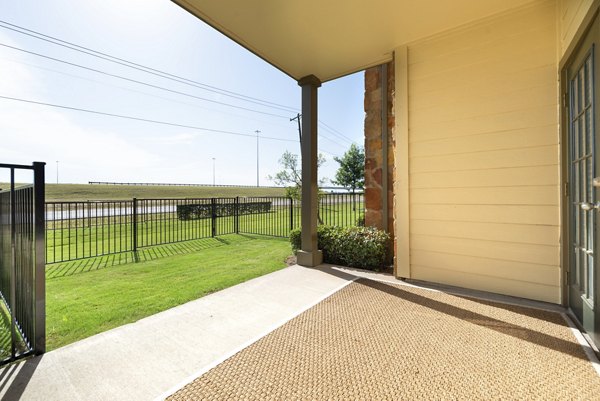 Spacious patio with modern outdoor seating at Olympus Team Ranch Apartments, perfect for relaxation and entertaining