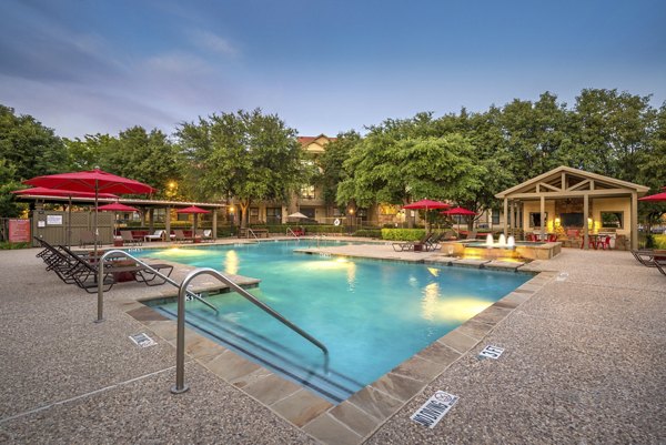 Resort-style pool with sundeck at Olympus Team Ranch Apartments