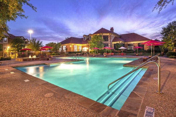 Olympus Team Ranch: Inviting poolside lounge area at luxury apartments