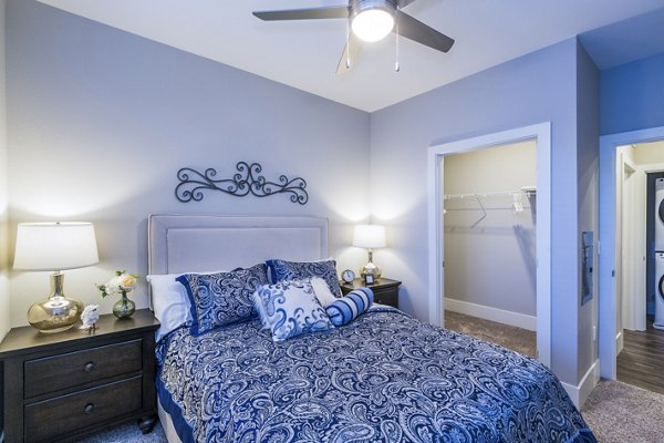 Stylish bedroom with modern furnishings at Retreat at Patriot Park Apartments