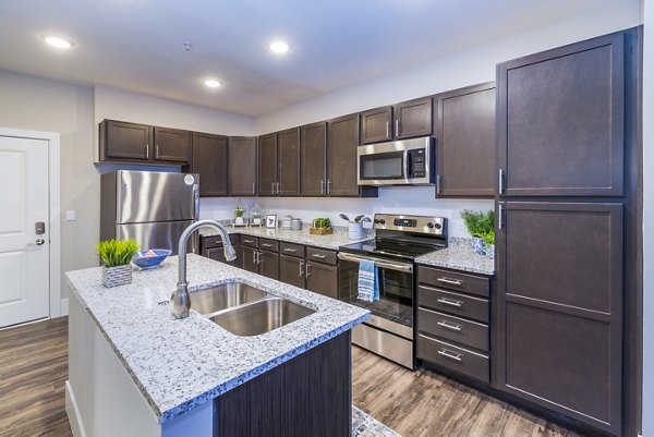 Modern kitchen with stainless steel appliances at Retreat at Patriot Park Apartments