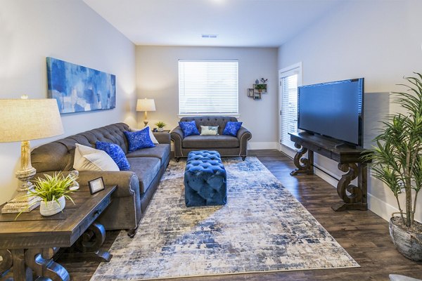 Spacious living room with contemporary furnishings in Retreat at Patriot Park Apartments, Greystar luxury apartments