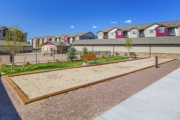 Bocce court with surrounding greenery at Retreat at Patriot Park Apartments