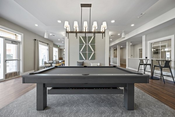 Clubhouse with modern design and cozy seating at Millyard at Meadow Commons Apartments